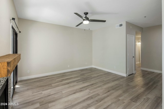 unfurnished living room featuring light hardwood / wood-style flooring and ceiling fan