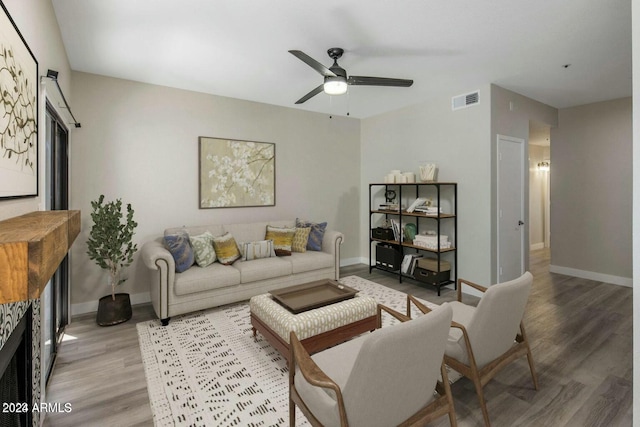 living room featuring hardwood / wood-style floors and ceiling fan