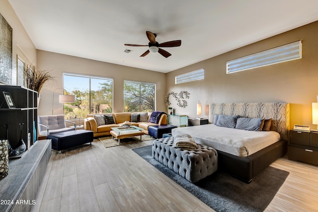 bedroom with ceiling fan and light wood-type flooring