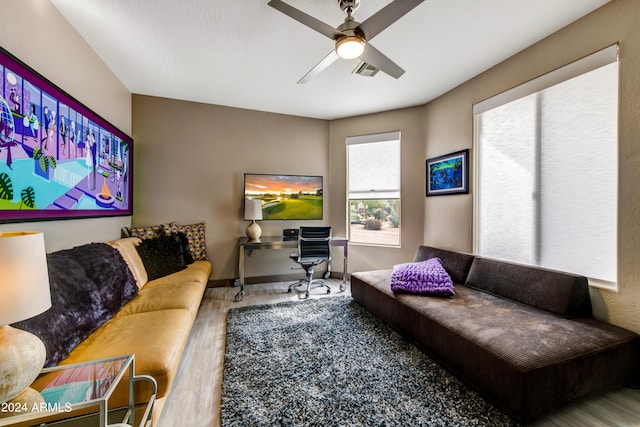 living room with wood-type flooring and ceiling fan