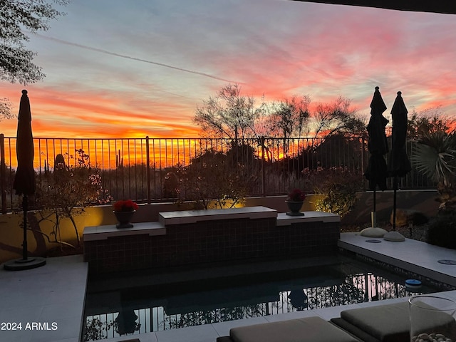 view of patio terrace at dusk