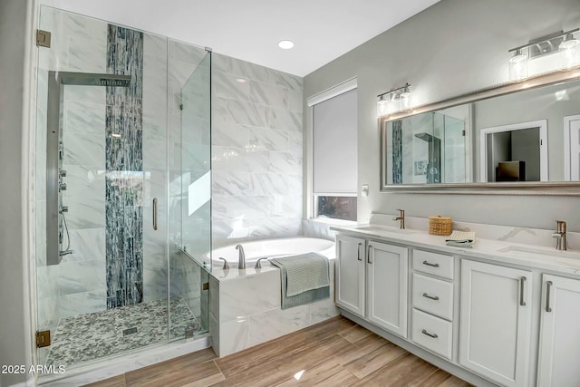 bathroom featuring vanity and separate shower and tub