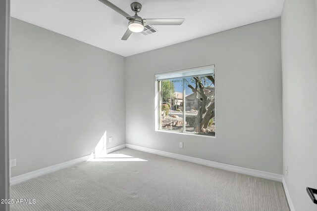 carpeted spare room with ceiling fan