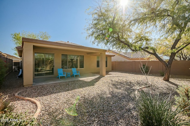 back of house with a patio