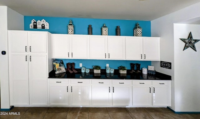 kitchen featuring white cabinetry and dark tile patterned floors