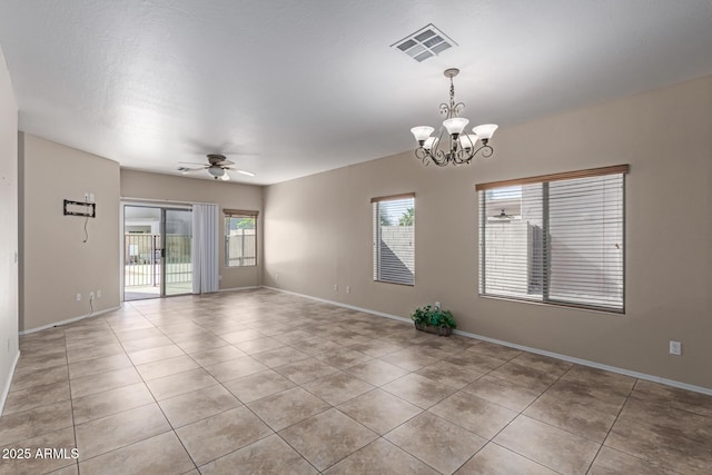 empty room with light tile patterned floors, baseboards, visible vents, and ceiling fan with notable chandelier