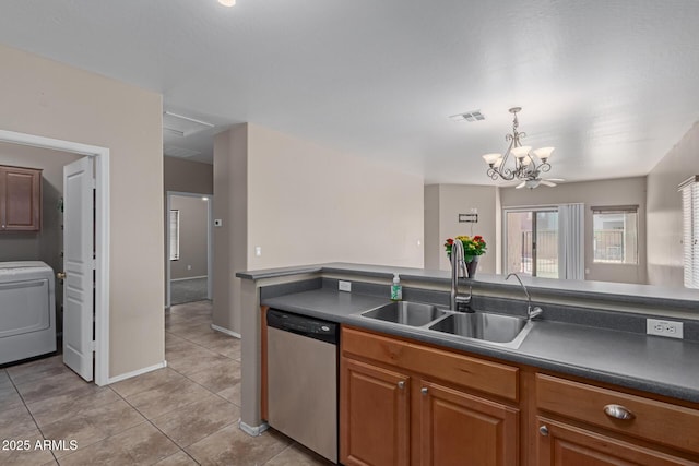 kitchen featuring dishwasher, washer / clothes dryer, dark countertops, and visible vents