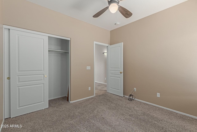 unfurnished bedroom featuring light carpet, a ceiling fan, baseboards, and a closet