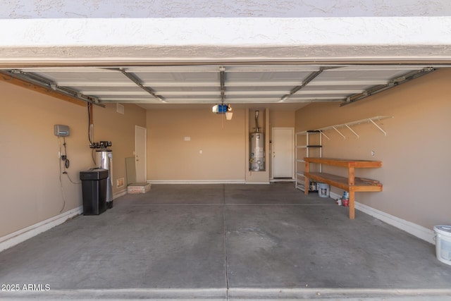 garage with baseboards, gas water heater, and a garage door opener