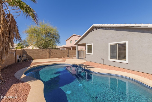 view of swimming pool featuring a fenced backyard and a fenced in pool