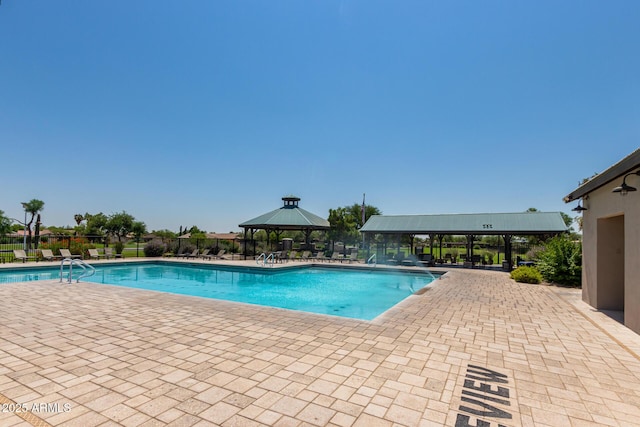 community pool featuring a gazebo and fence