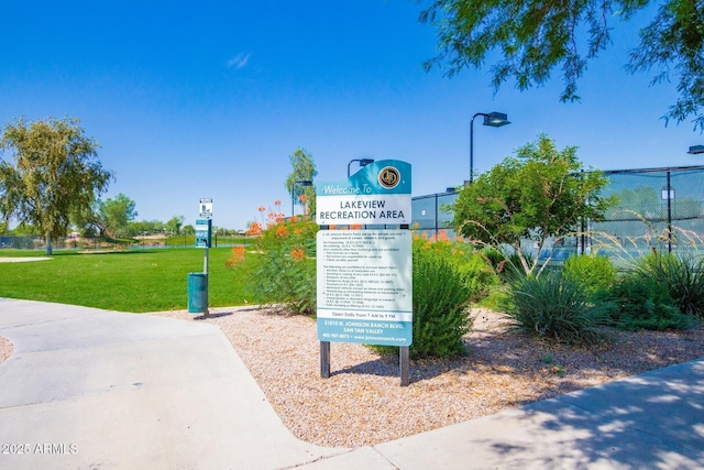 view of home's community featuring fence and a yard