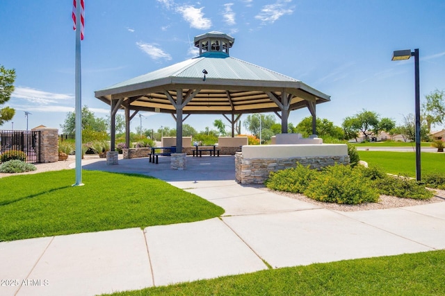 view of home's community with a patio area, a lawn, and a gazebo