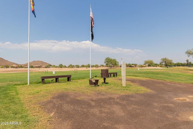 view of community featuring a lawn and a mountain view