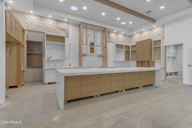 kitchen featuring white cabinets, backsplash, and a high ceiling