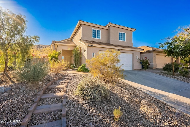 view of front property with a mountain view and a garage