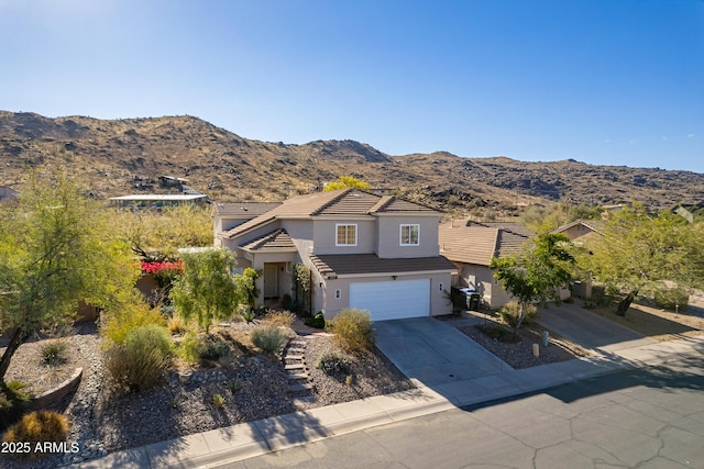 view of property featuring a garage and a mountain view