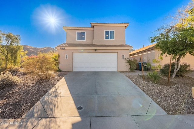 view of front of house featuring a mountain view and a garage