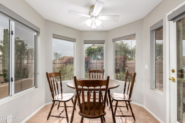 tiled dining room with ceiling fan