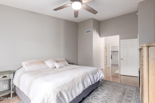 tiled bedroom featuring ceiling fan