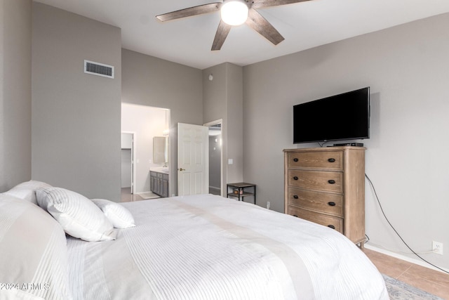 bedroom featuring connected bathroom, ceiling fan, and light tile patterned floors