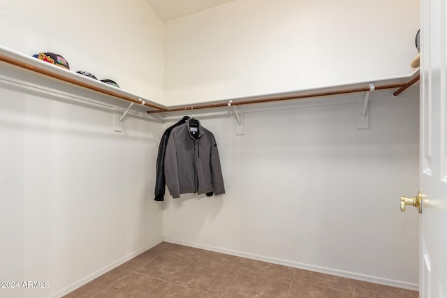 walk in closet featuring light tile patterned flooring