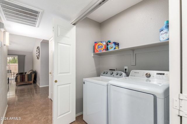 laundry room with separate washer and dryer and light tile patterned floors