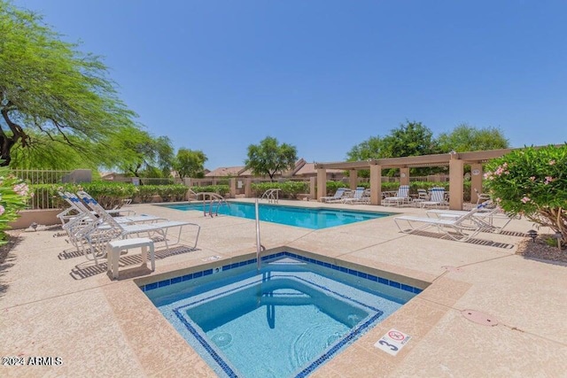 view of swimming pool featuring a community hot tub and a patio