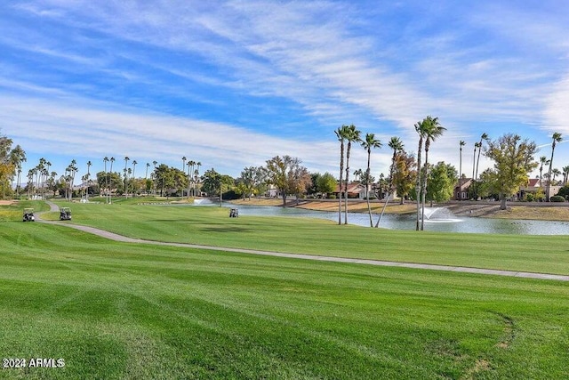 view of home's community with a lawn and a water view