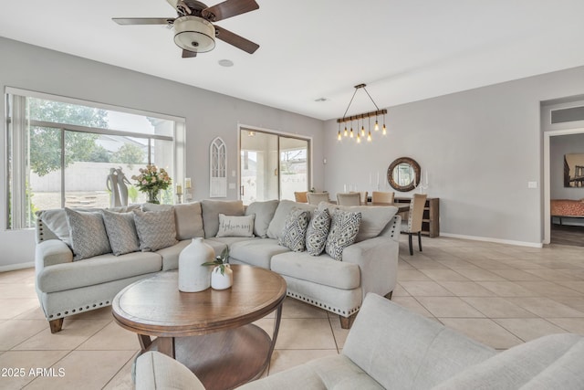 tiled living room with ceiling fan