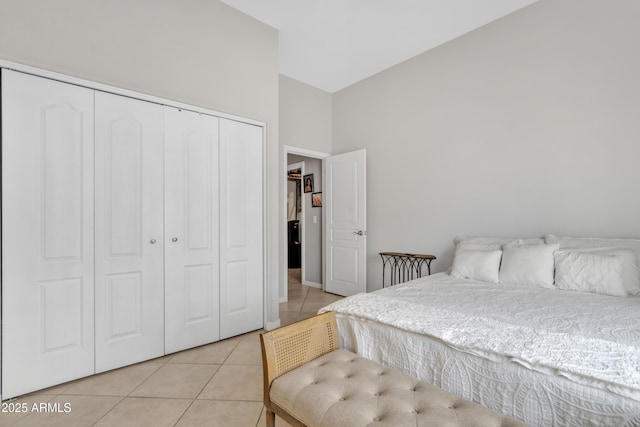 bedroom with light tile patterned floors and a closet