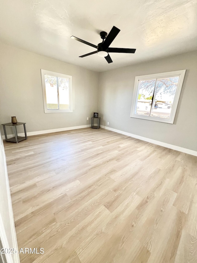 empty room with light hardwood / wood-style floors and ceiling fan