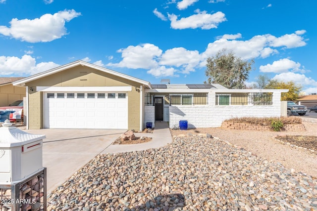 single story home featuring a garage and solar panels