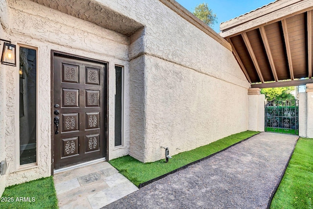 entrance to property with stucco siding