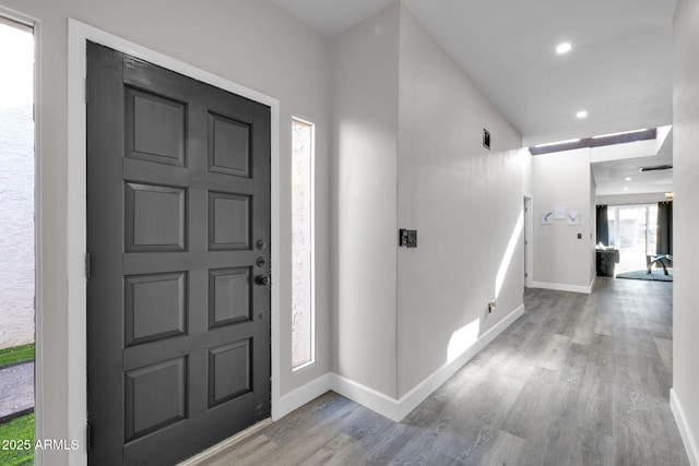 foyer entrance featuring recessed lighting, wood finished floors, and baseboards