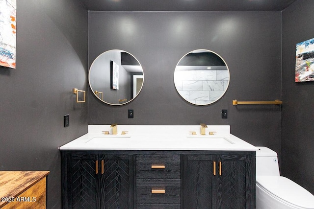 full bathroom with a sink, toilet, and double vanity