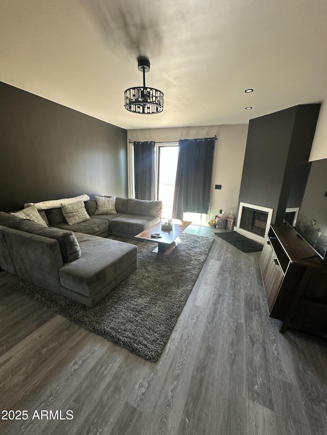 living area featuring a glass covered fireplace and wood finished floors