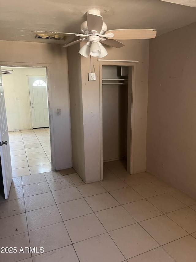 527 S Macdonald, Mesa, AZ 85210 - unfurnished bedroom with light tile patterned floors, a closet, and a ceiling fan