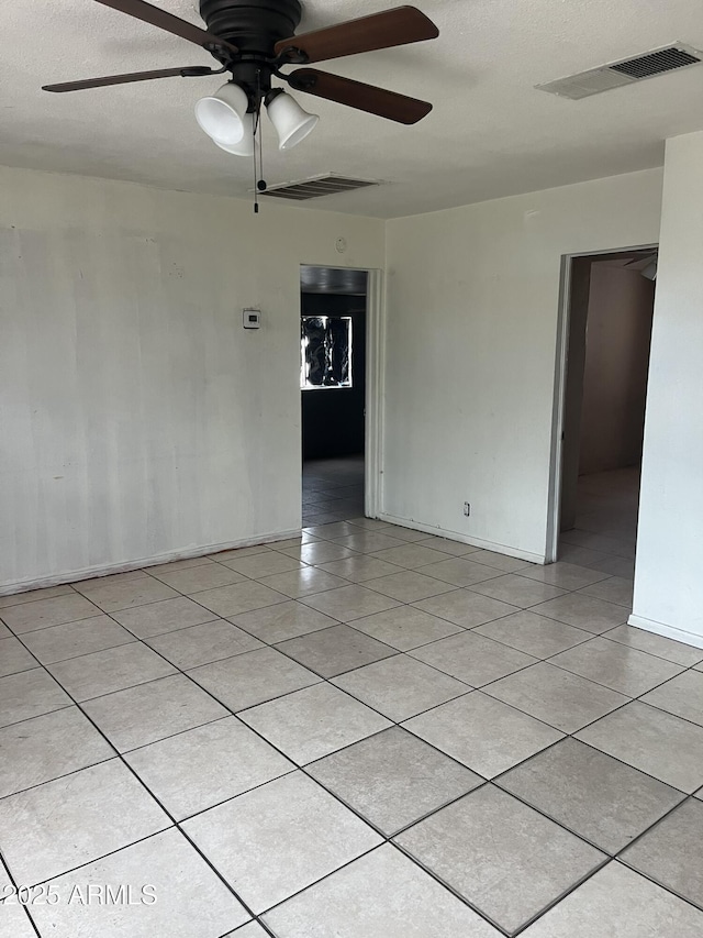 527 S Macdonald, Mesa, AZ 85210 - unfurnished room with light tile patterned flooring, ceiling fan, and baseboards