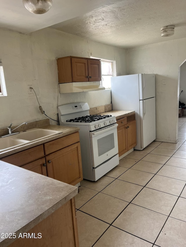 527 S Macdonald, Mesa, AZ 85210 - kitchen with white appliances, a sink, under cabinet range hood, light tile patterned flooring, and light countertops