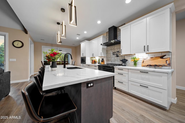 1500 W Pinetree Ct, Show Low, AZ 85901 - kitchen featuring wall chimney range hood, backsplash, white cabinetry, light wood-style flooring, and recessed lighting