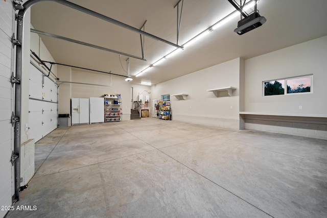 1500 W Pinetree Ct, Show Low, AZ 85901 - garage featuring a garage door opener and freestanding refrigerator