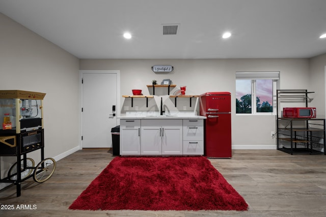 1500 W Pinetree Ct, Show Low, AZ 85901 - kitchen with light wood-style flooring, recessed lighting, white cabinets, light countertops, and open shelves