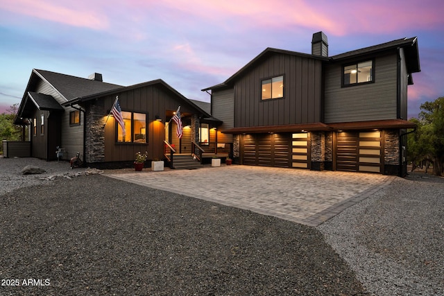 1500 W Pinetree Ct, Show Low, AZ 85901 - view of front of property with a chimney, a garage, decorative driveway, stone siding, and board and batten siding