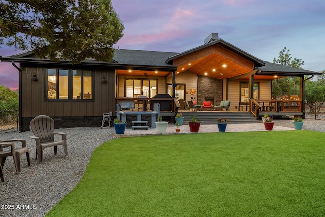 1500 W Pinetree Ct, Show Low, AZ 85901 - back of property at dusk with a lawn, crawl space, board and batten siding, and a shingled roof