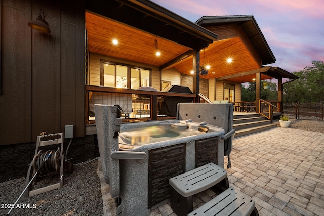 1500 W Pinetree Ct, Show Low, AZ 85901 - patio terrace at dusk featuring a hot tub and a patio