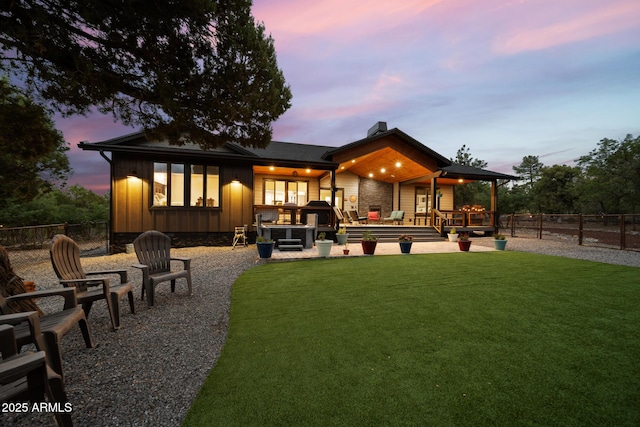 1500 W Pinetree Ct, Show Low, AZ 85901 - back of property at dusk featuring a chimney, board and batten siding, and a deck