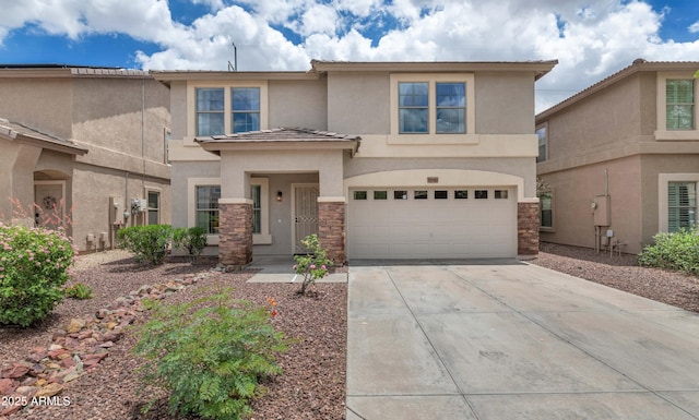 1821 E Patrick Ln, Phoenix, AZ 85024 - view of front facade with stucco siding, concrete driveway, stone siding, and an attached garage