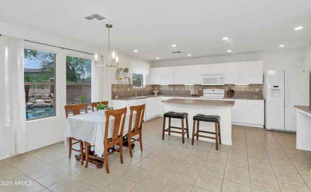 1821 E Patrick Ln, Phoenix, AZ 85024 - dining room with light tile patterned floors, a chandelier, and recessed lighting