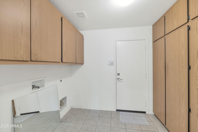 1821 E Patrick Ln, Phoenix, AZ 85024 - washroom with cabinet space, electric dryer hookup, light tile patterned floors, washer hookup, and baseboards